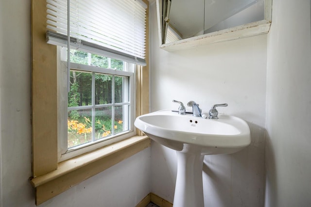 bathroom featuring a healthy amount of sunlight and lofted ceiling