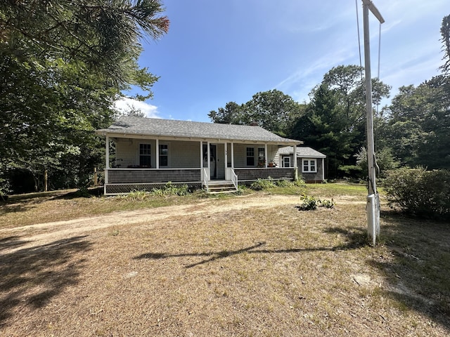 ranch-style home with a porch and a front lawn