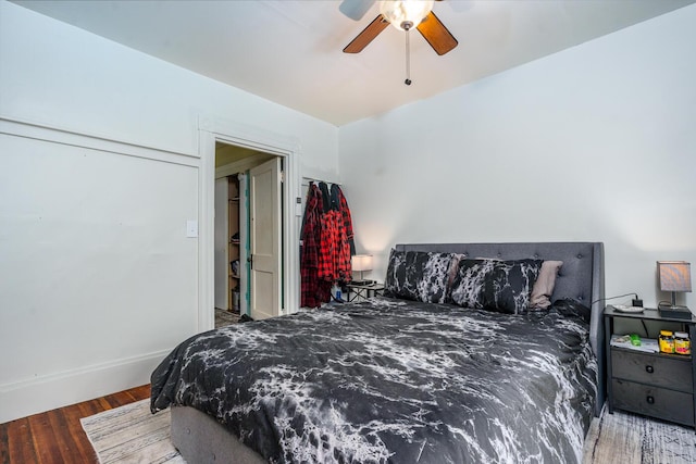 bedroom with ceiling fan and dark hardwood / wood-style flooring