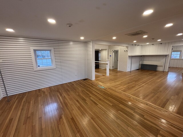 unfurnished living room with light wood-style flooring, visible vents, and recessed lighting