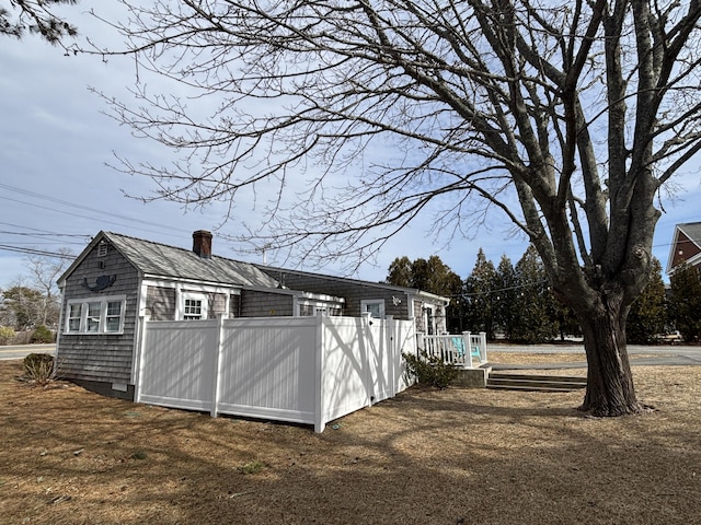 view of outbuilding featuring fence