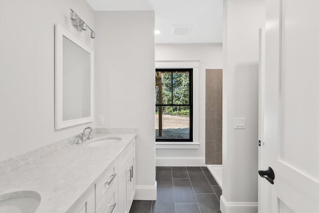 bathroom featuring a shower, tile patterned floors, and vanity