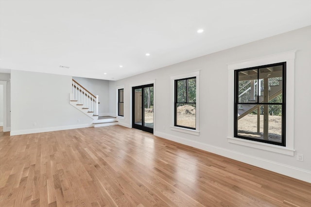 unfurnished living room with light hardwood / wood-style flooring