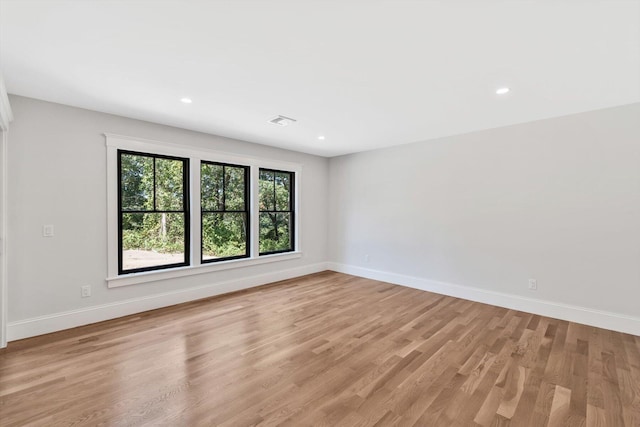 unfurnished room with light hardwood / wood-style flooring