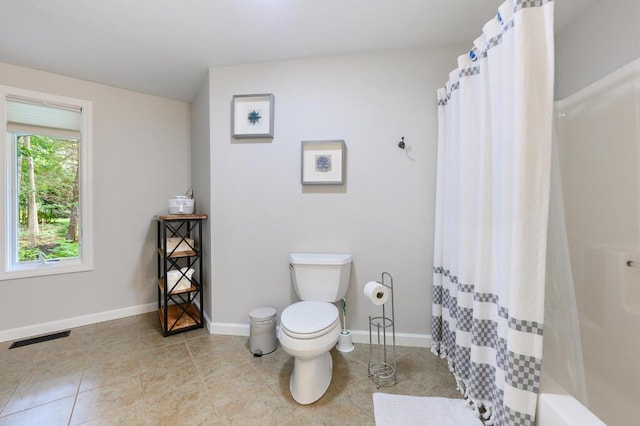 bathroom featuring toilet and tile patterned flooring