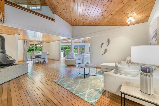 living room featuring a wood stove, high vaulted ceiling, wooden ceiling, and wood-type flooring