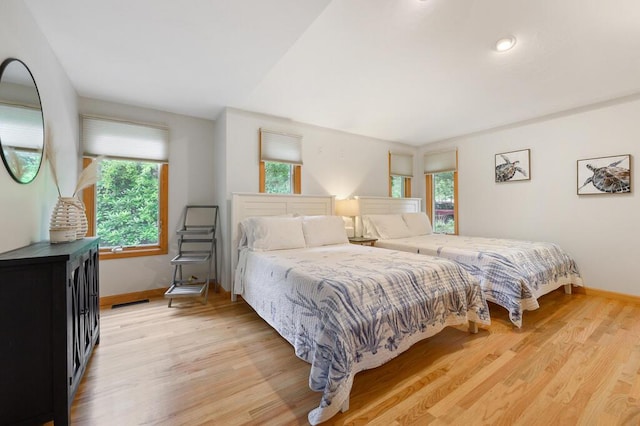 bedroom featuring light hardwood / wood-style floors and multiple windows