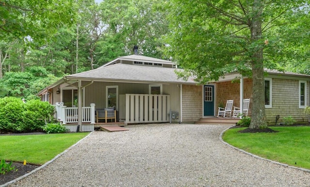 view of front of home with a front yard and a porch