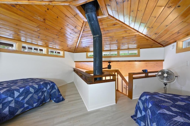 bedroom featuring light hardwood / wood-style floors, wooden ceiling, and vaulted ceiling