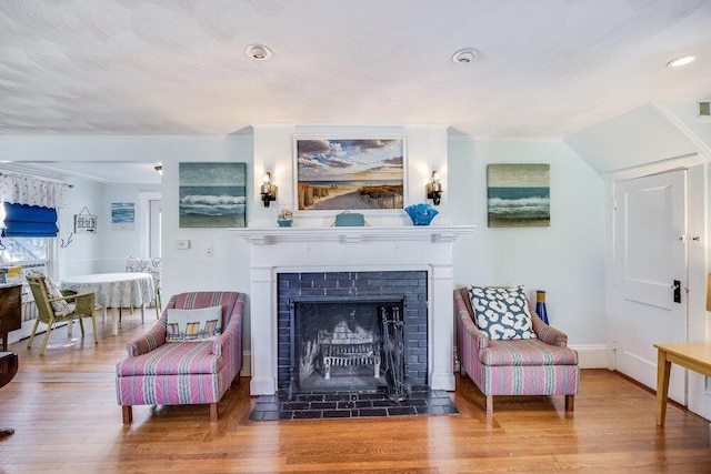 281 Gosnold St, Hyannis, MA 02601 - living area featuring wood finished floors, a fireplace with flush hearth, recessed lighting, and baseboards