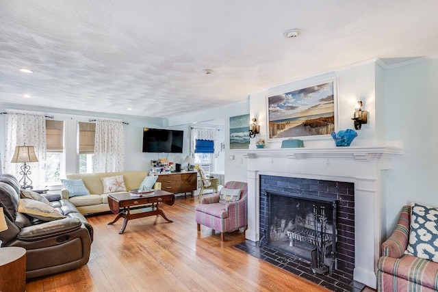 281 Gosnold St, Hyannis, MA 02601 - living room with plenty of natural light, ornamental molding, a fireplace with flush hearth, wood finished floors, and recessed lighting