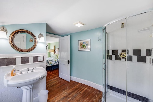 281 Gosnold St, Hyannis, MA 02601 - full bathroom featuring wood finished floors, a shower stall, connected bathroom, and baseboards