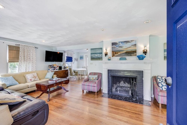 281 Gosnold St, Hyannis, MA 02601 - living room featuring wood finished floors, a fireplace with flush hearth, and recessed lighting