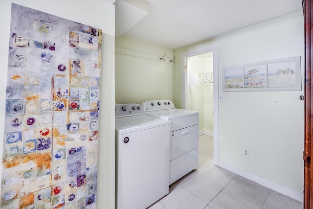 281 Gosnold St, Hyannis, MA 02601 - laundry area featuring washing machine and dryer, light tile patterned flooring, and baseboards