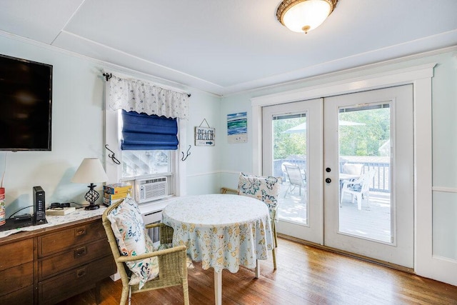 281 Gosnold St, Hyannis, MA 02601 - dining area featuring french doors, light wood finished floors, cooling unit, and crown molding