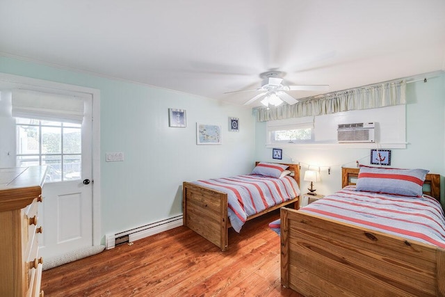 281 Gosnold St, Hyannis, MA 02601 - bedroom with baseboard heating, an AC wall unit, light wood-type flooring, ceiling fan, and ornamental molding