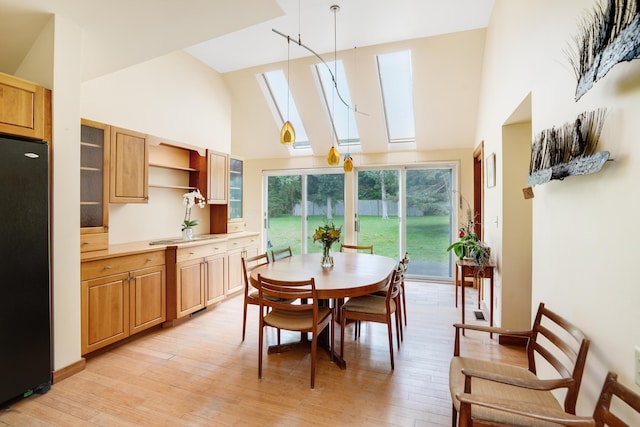 174 Middle Rd, Chilmark, MA 02535 - dining area with high vaulted ceiling, a skylight, and light wood-type flooring
