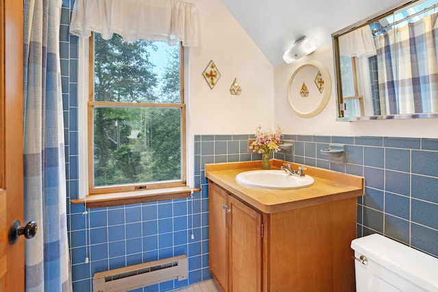 174 Middle Rd, Chilmark, MA 02535 - bathroom featuring tile walls, baseboard heating, vanity, vaulted ceiling, and a wainscoted wall