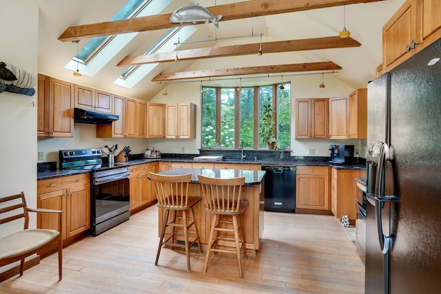 174 Middle Rd, Chilmark, MA 02535 - kitchen featuring black appliances, a skylight, under cabinet range hood, beamed ceiling, and light wood-style flooring