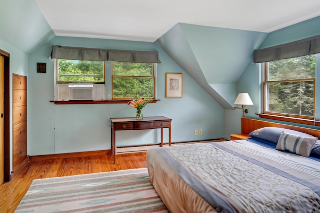 174 Middle Rd, Chilmark, MA 02535 - bedroom featuring vaulted ceiling, multiple windows, wood finished floors, a baseboard radiator, and cooling unit