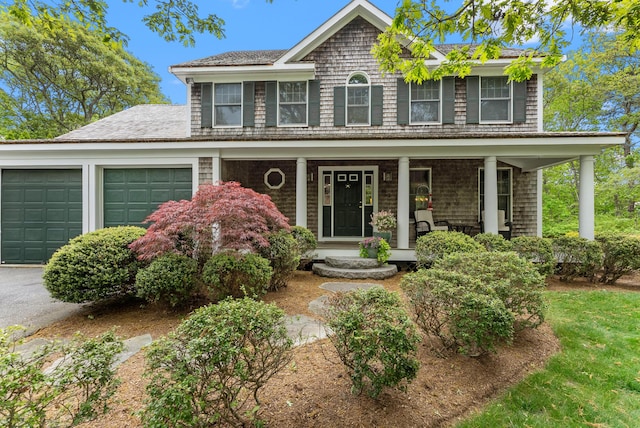 5 Bayes Hill Cir, Oak Bluffs, MA 02557 - view of front of home with a garage, a porch, and roof with shingles