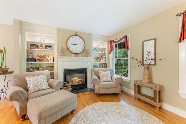 5 Bayes Hill Cir, Oak Bluffs, MA 02557 - living area with a fireplace with flush hearth, wood finished floors, and baseboards