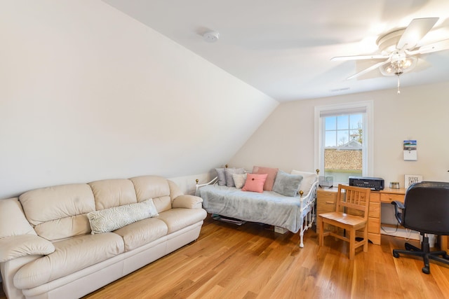 bedroom featuring a ceiling fan, light wood-style floors, and vaulted ceiling