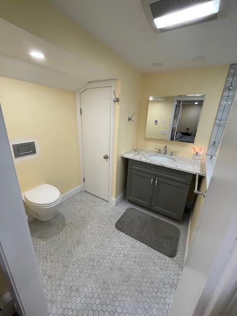 bathroom with tile patterned flooring, vanity, and toilet