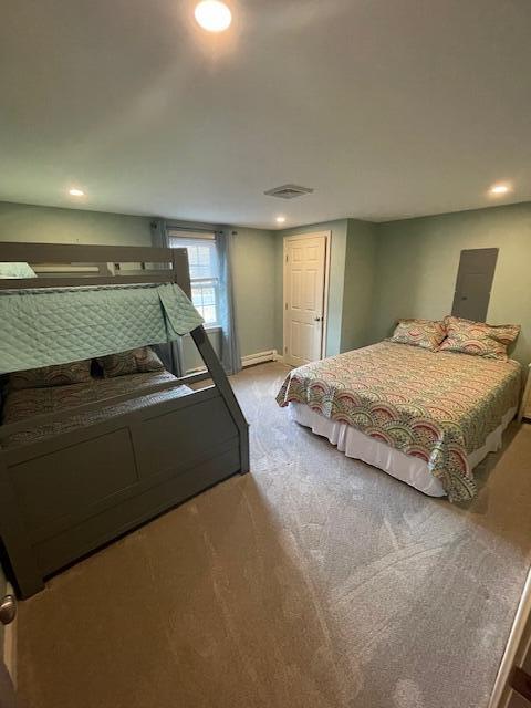 carpeted bedroom featuring a baseboard radiator