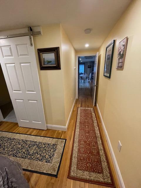 hall featuring hardwood / wood-style flooring and a barn door