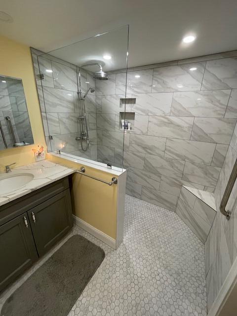 bathroom featuring vanity and a tile shower