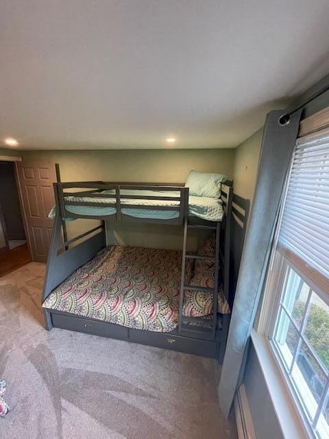 carpeted bedroom with multiple windows