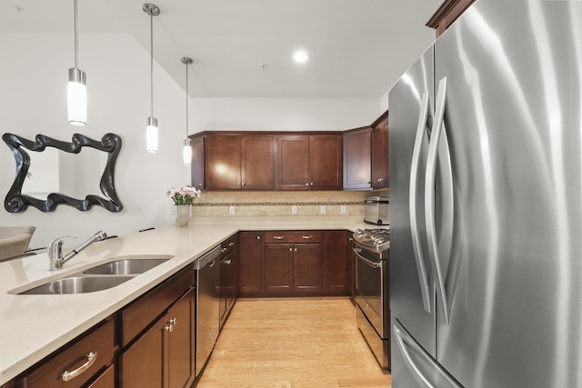21 Grey Hawk Dr, Mashpee, MA 02649 - kitchen featuring stainless steel appliances, a sink, light wood-style flooring, pendant lighting, and tasteful backsplash