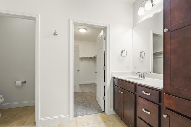 21 Grey Hawk Dr, Mashpee, MA 02649 - bathroom featuring tile patterned flooring, vanity, baseboards, toilet, and a spacious closet