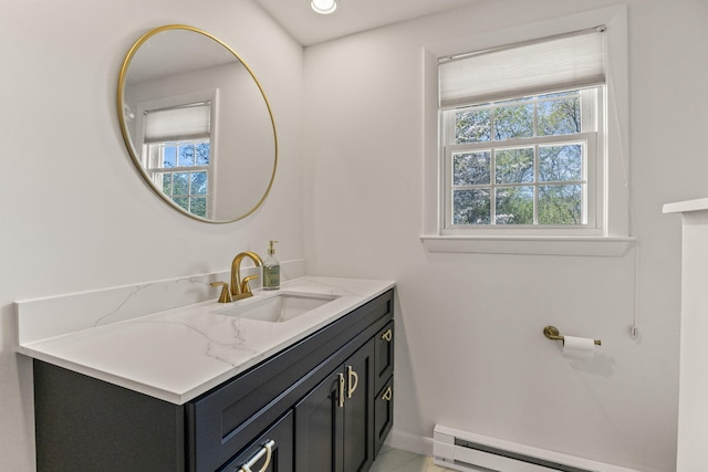 bathroom with vanity, a baseboard radiator, and baseboards