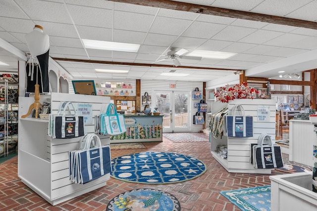 misc room featuring a paneled ceiling and ceiling fan