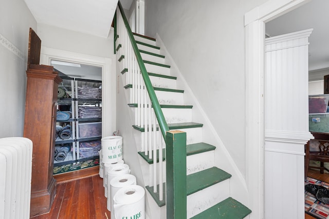 stairs with radiator and hardwood / wood-style floors