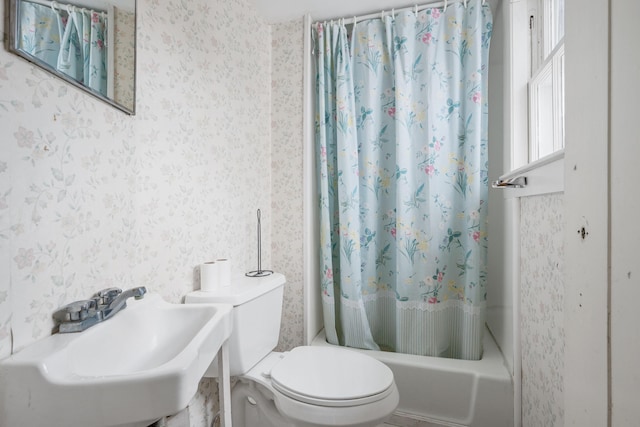 full bathroom featuring sink, shower / bath combination with curtain, and toilet