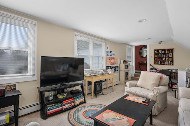 carpeted living room with a wealth of natural light, vaulted ceiling, and a baseboard heating unit