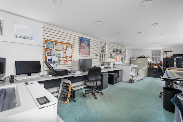 office space featuring carpet, wood walls, and a workshop area