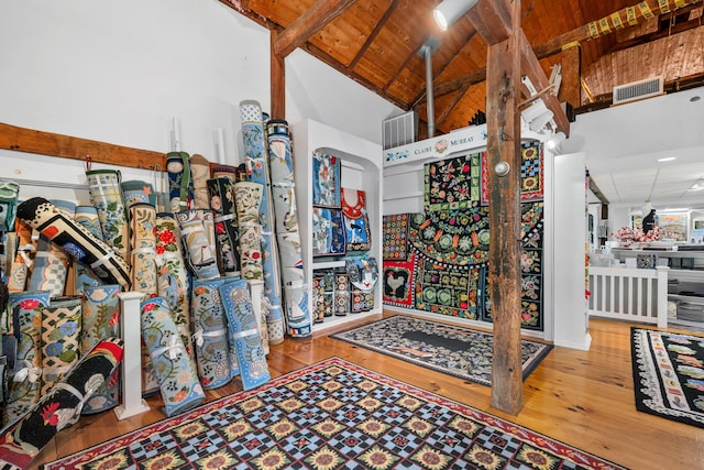 miscellaneous room with beamed ceiling, high vaulted ceiling, hardwood / wood-style floors, and wooden ceiling