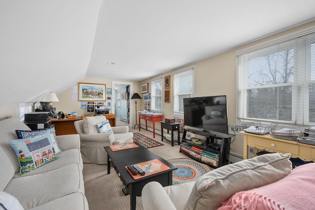 living room with light carpet, vaulted ceiling, and a baseboard radiator