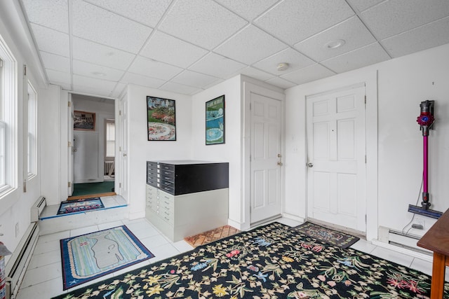 entrance foyer featuring a baseboard radiator and a paneled ceiling