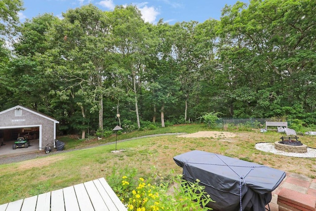 196 Commons Way, Brewster, MA 02631 - view of green lawn with a fire pit, an outdoor structure, and a detached garage