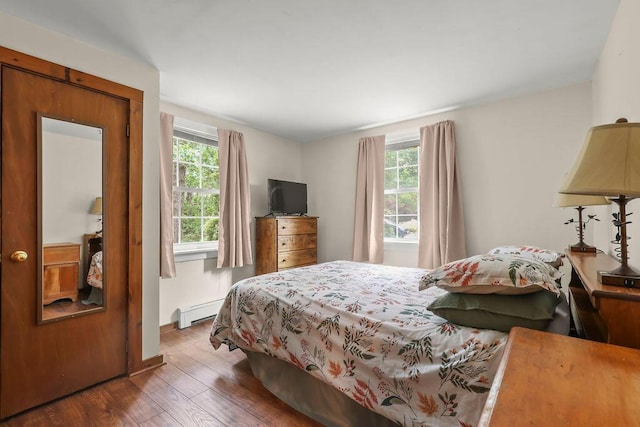 196 Commons Way, Brewster, MA 02631 - bedroom with wood-type flooring and a baseboard heating unit