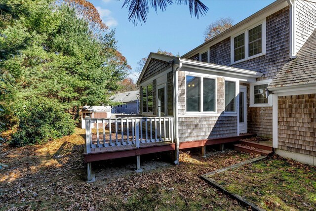 rear view of property featuring a deck