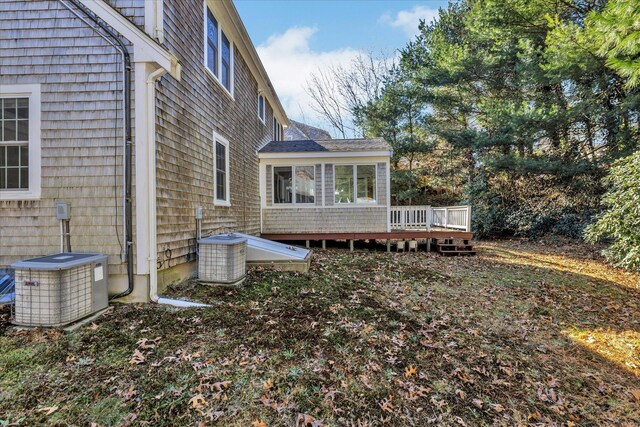 view of side of home with a deck and central AC unit