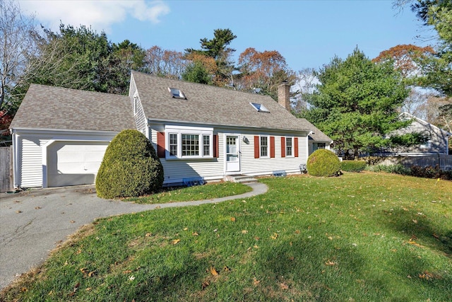 new england style home with a garage and a front lawn