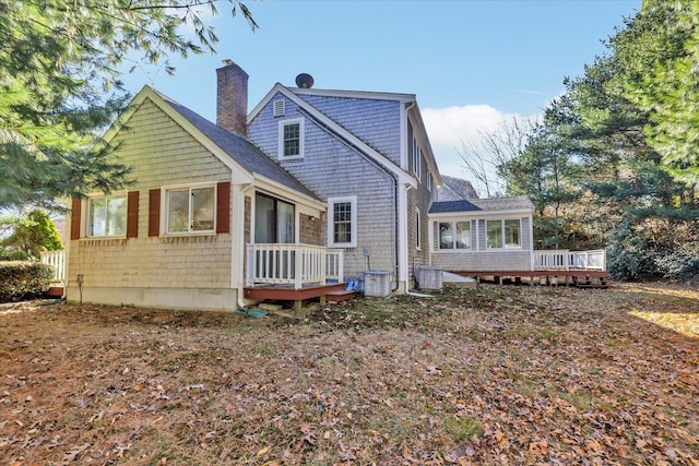 rear view of house featuring central AC unit and a deck