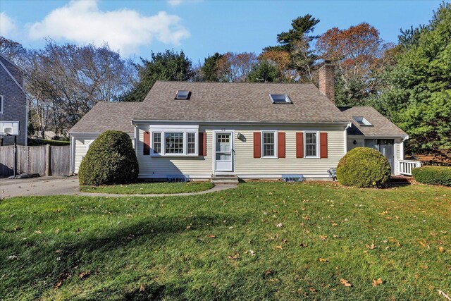 cape cod house with a front lawn